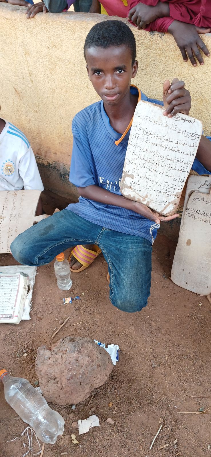 Boy showing his Quran wooden board